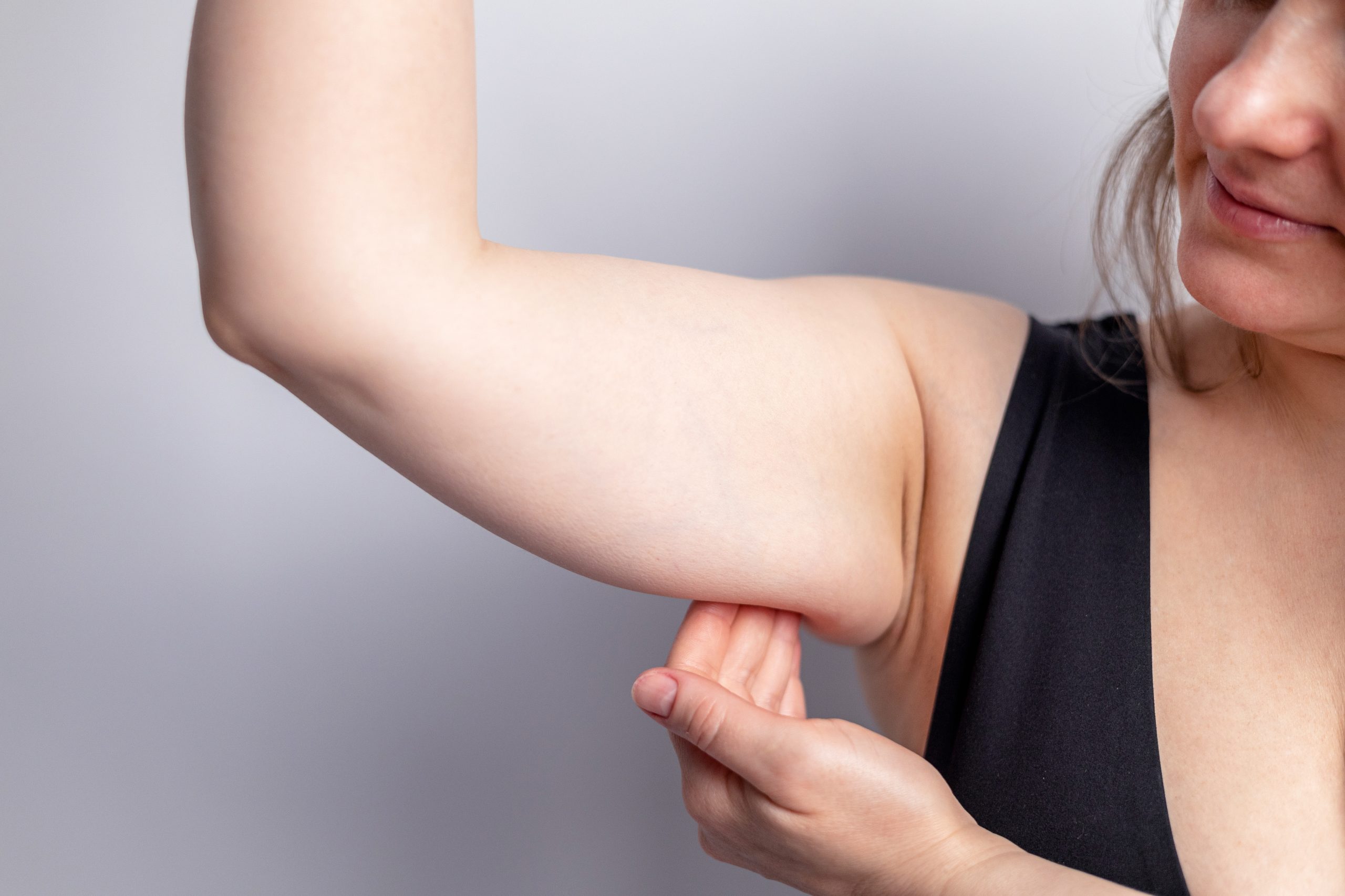Cropped,Shot,Of,A,Young,Woman,Grabbing,And,Shaking,Skin