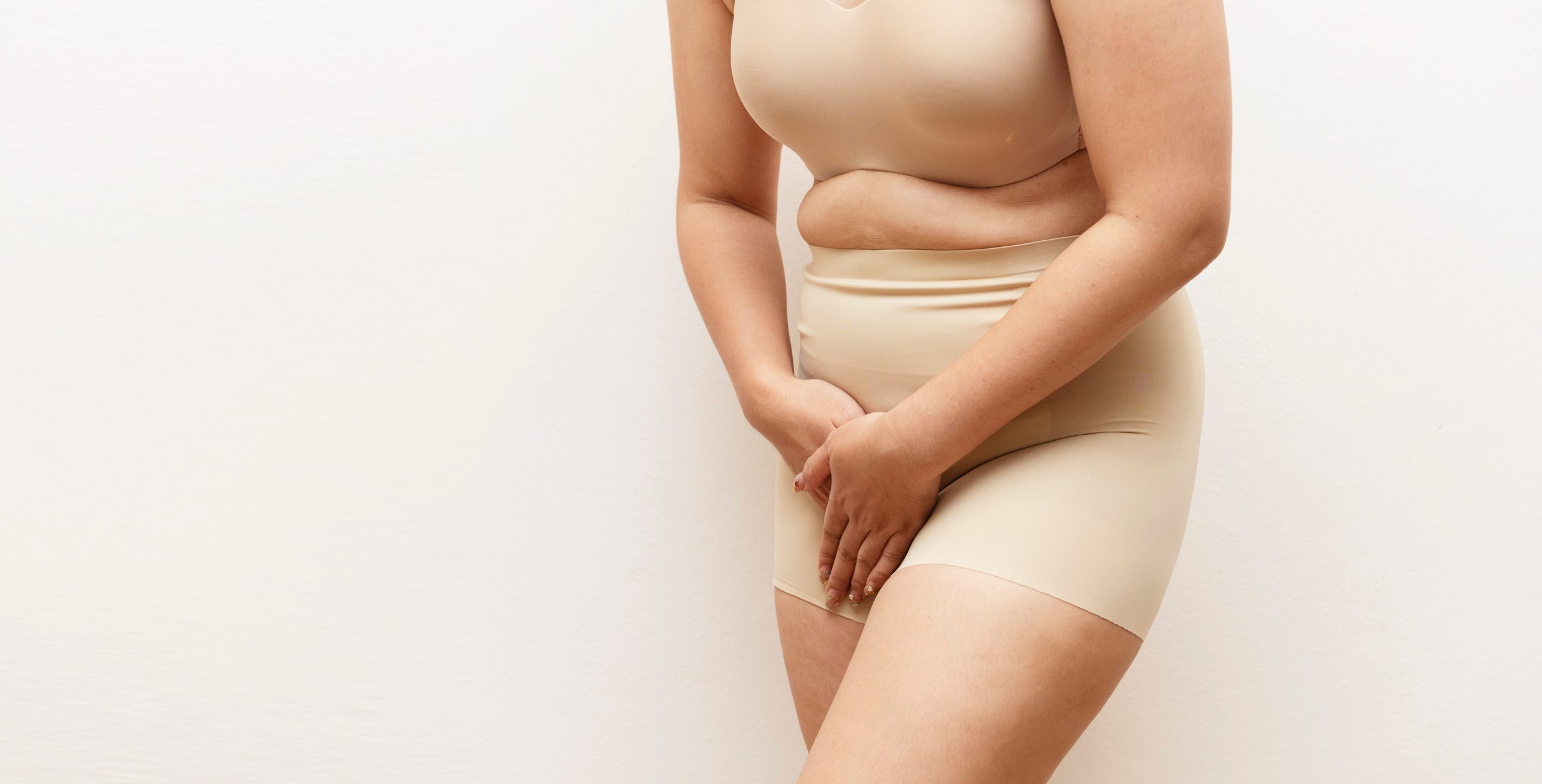 Woman,Holding,Lower,Abdomen,With,Both,Hands